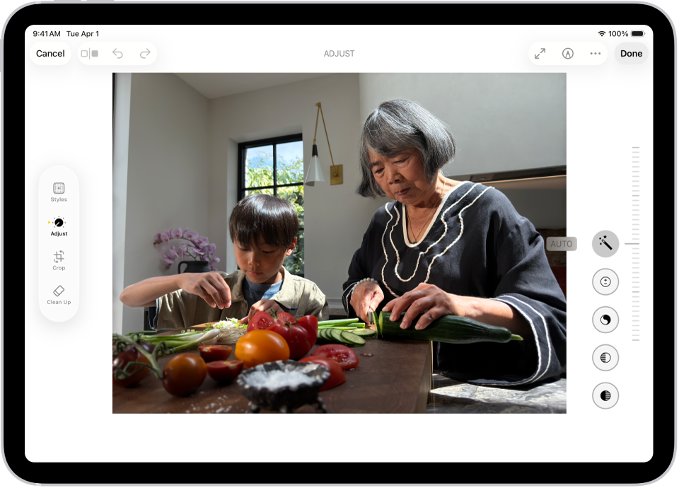 The Edit screen of the Photos app showing a photo in the center. To the left of the photo are the Style, Adjust, Crop, and Clean Up buttons; Adjust is selected. To the right of the photo are buttons for editing effects and a slider to adjust each effect level.